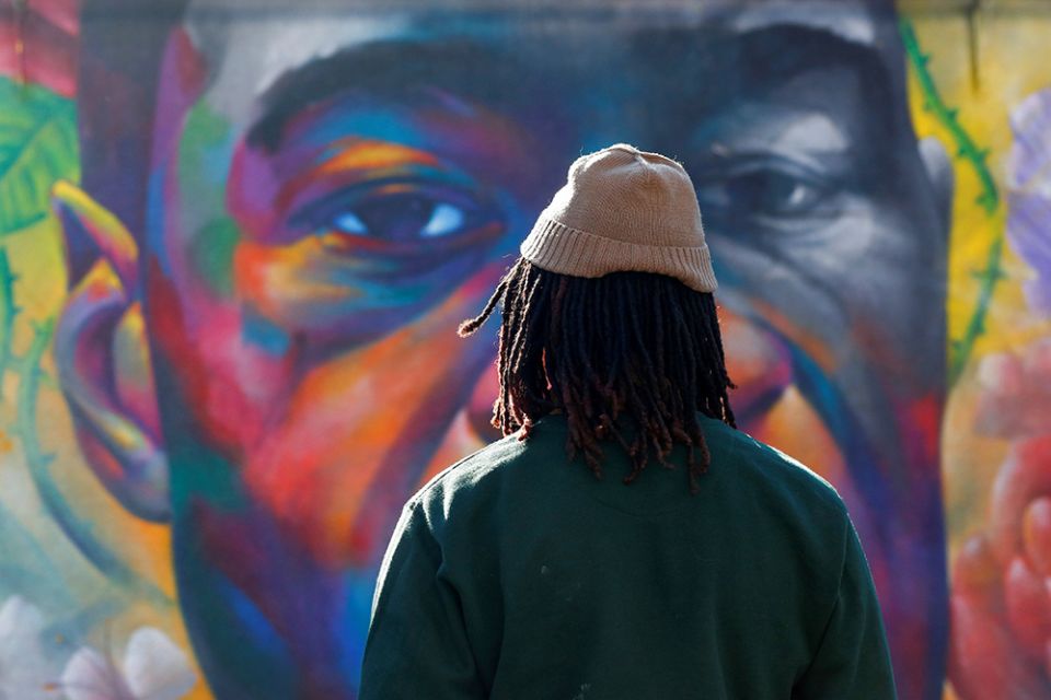 A person in Denver is seen at a George Floyd mural April 20 after jurors issued their verdict convicting former Minneapolis police officer Derek Chauvin of second-degree unintentional murder, third-degree murder and second-degree manslaughter. (CNS) A person in Denver is seen at a George Floyd mural April 20 after jurors issued their verdict convicting former Minneapolis police officer Derek Chauvin of second-degree unintentional murder, third-degree murder and second-degree manslaughter. (CNS)