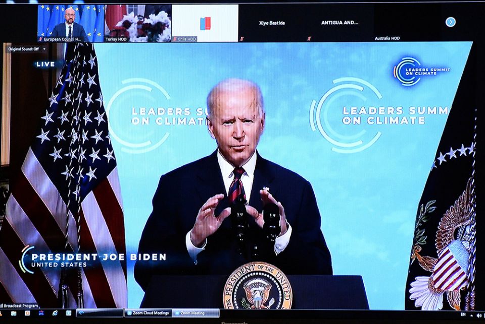 President Joe Biden is seen on a screen in Brussels, Belgium, April 22, 2021, as European Council President Charles Michel attends a virtual global climate summit. Biden committed the United States to cut greenhouse emissions in half by 2030. (CNS/Johanna