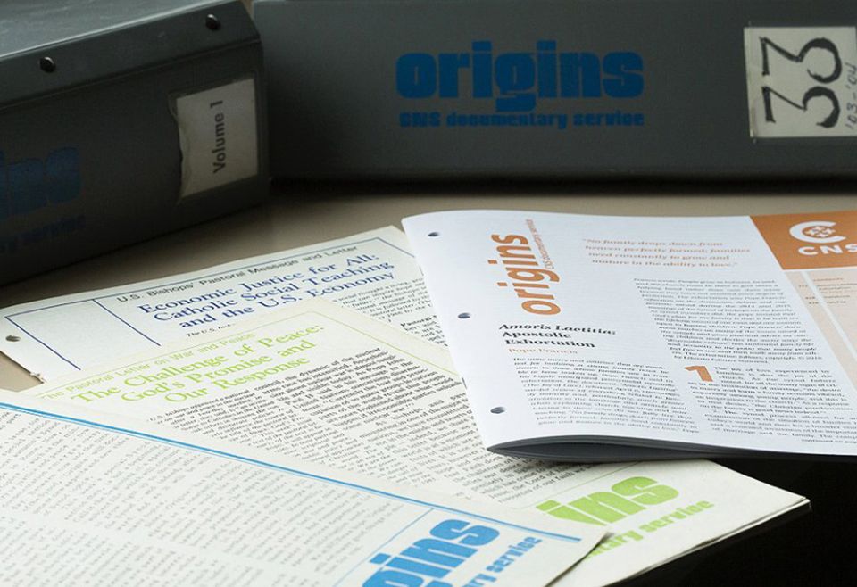 Some issues of Origins, the documentary service of Catholic News Service, are seen in this undated photo, along with binders for entire volumes of the publication. (CNS/Tyler Orsburn)