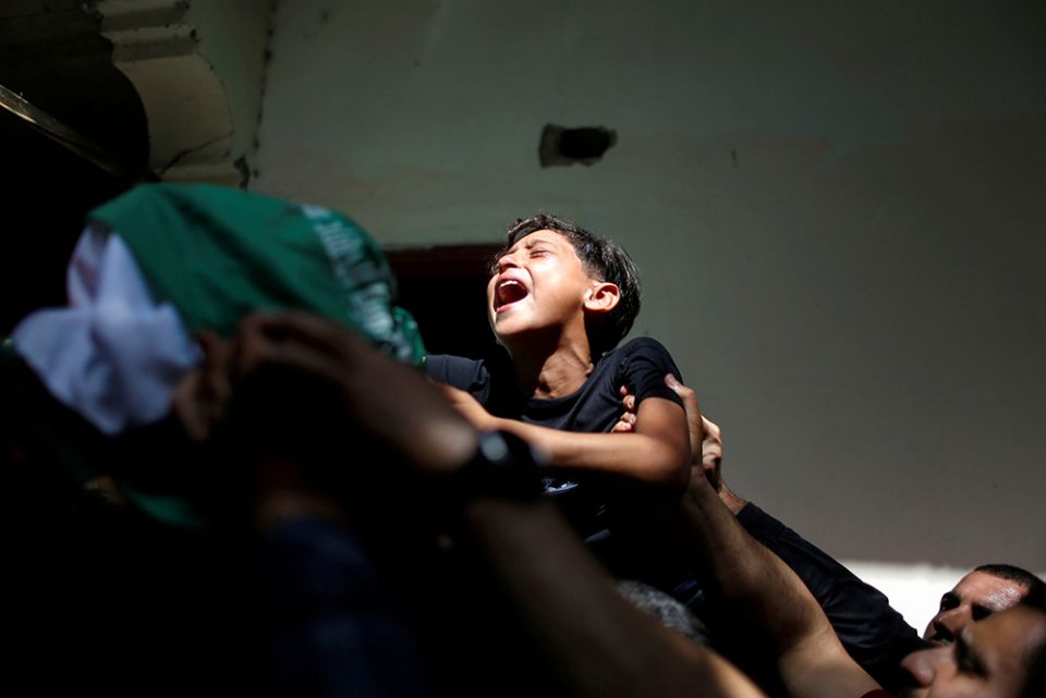 The brother of Palestinian Ahmed al-Shenbari, who was killed during Israeli-Palestinian violence, cries during his funeral in the Gaza Strip May 11. (CNS/Reuters/Mohammed Salem)