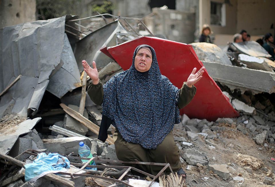 A Palestinian woman reacts after returning to her destroyed house in Gaza May 21, following the Israel-Hamas truce. The May 21 truce followed more than a week of fighting that claimed hundreds of lives. (CNS/Reuters/Ibraheem Abu Mustafa)