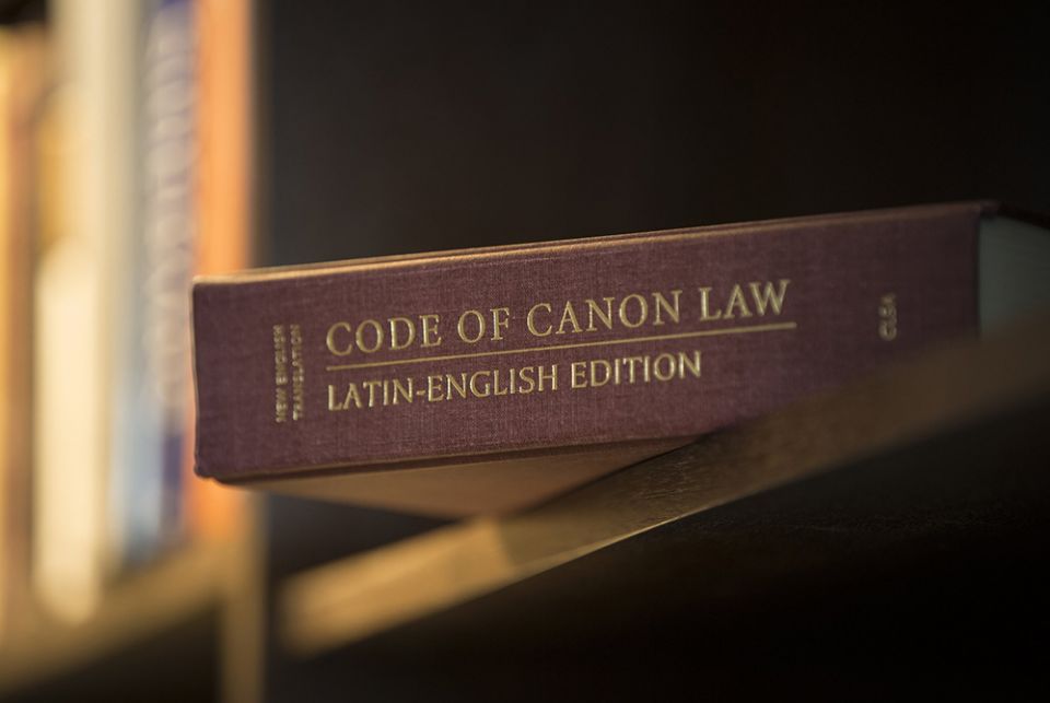 A Latin-English edition of the Code of Canon Law is pictured on a bookshelf. (CNS/Nancy Phelan Wiechec)