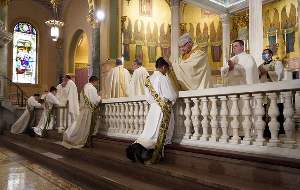 Four ordinands kneel as priests lay hands on them during their ordination to the priesthood June 5 at the Co-Cathedral of St. Joseph in Brooklyn, New York. (CNS/Gregory A. Shemitz)