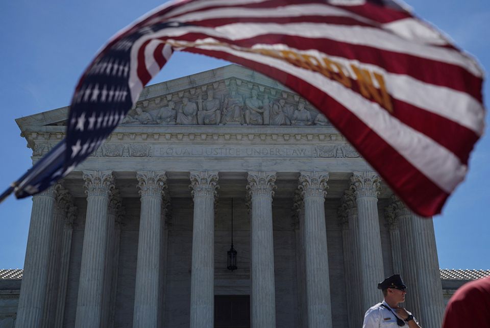 A U.S. flag flies in front of the Supreme Court June 25, 2018, in Washington. (CNS/Reuters/Toya Sarno Jordan)