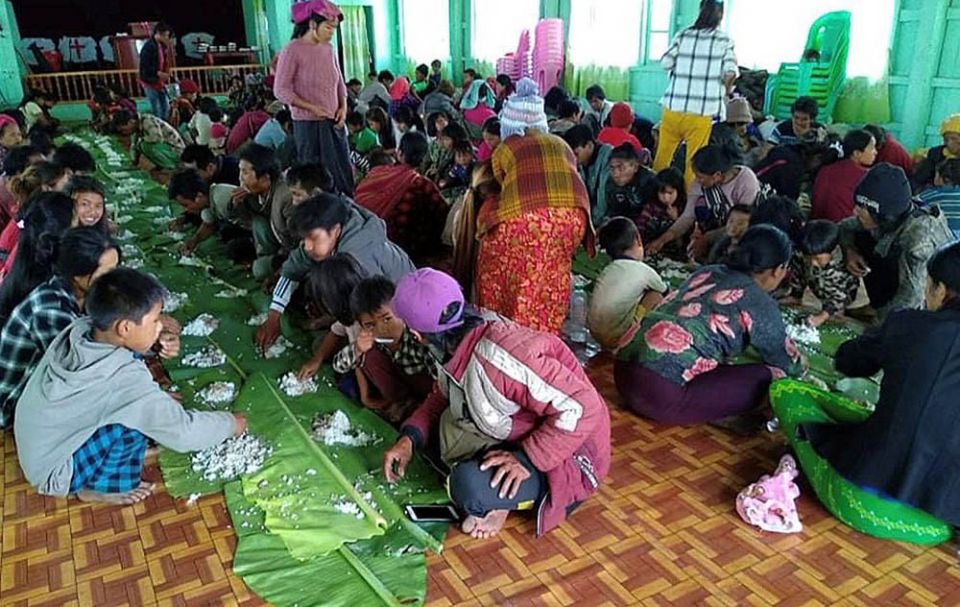 People displaced by fighting in northwestern Myanmar eat at a shelter in Chin state May 31. (CNS/Reuters)