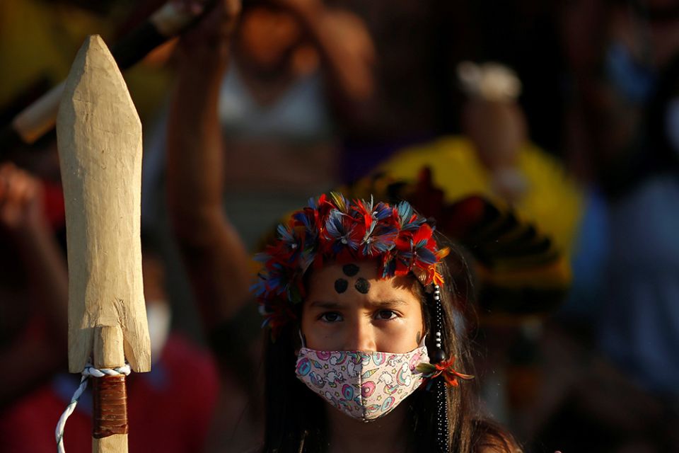 A young Indigenous person takes part in a protest for land demarcation and against Brazilian President Jair Bolsonaro's government, outside the supreme court in Brasília June 18, 2021. (CNS/Reuters/Adriano Machado)