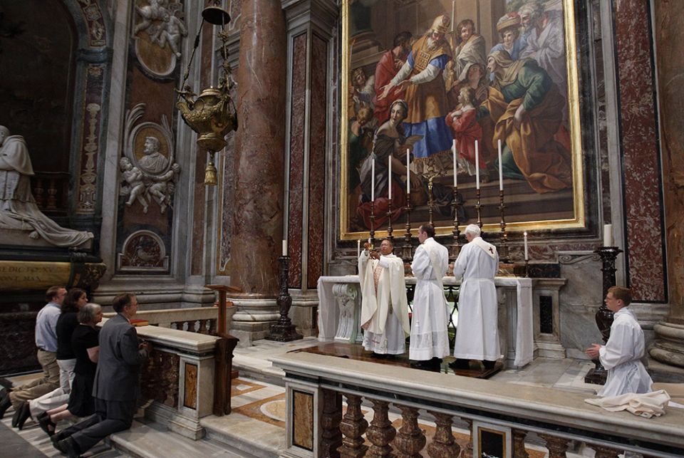 A priest holds the Eucharist as he celebrates a private Mass at a chapel in St. Peter's Basilica at the Vatican in this Oct. 8, 2011, file photo. (CNS/Paul Haring) A priest holds the Eucharist as he celebrates a private Mass at a chapel in St. Peter's Basilica at the Vatican in this Oct. 8, 2011, file photo. (CNS/Paul Haring)