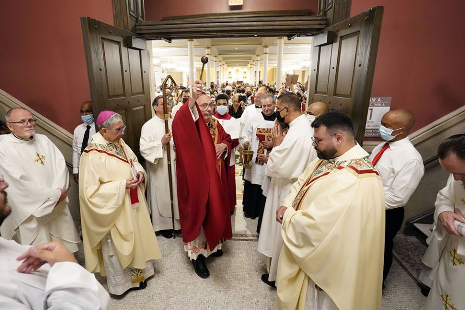 Bishop Nicholas DiMarzio of Brooklyn, New York, uses holy water during the dedication of Sts. Peter & Paul Church in Brooklyn June 29, the feast of Sts. Peter and Paul. (CNS/Gregory A. Shemitz)