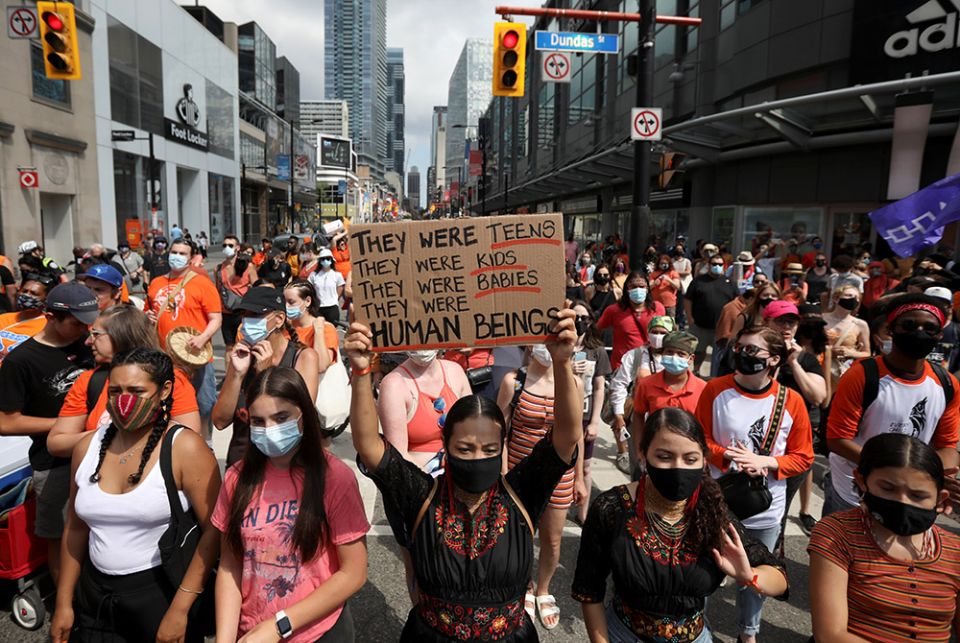 People take part in a march on Canada Day in Toronto July 1, after the discovery of hundreds of unmarked graves on the grounds of former residential schools for Indigenous children in Canada. (CNS/Reuters/Carlos Osorio) People take part in a march on Canada Day in Toronto July 1, after the discovery of hundreds of unmarked graves on the grounds of former residential schools for Indigenous children in Canada. (CNS/Reuters/Carlos Osorio)