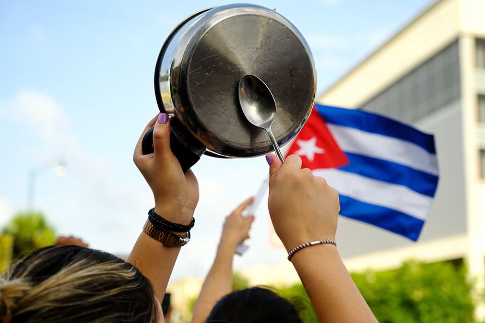 A demonstrator in the Little Havana neighborhood of Miami bangs on a pot July 12, as people rally in solidarity with protesters in Cuba. (CNS/Reuters/Maria Alejandra Cardona)