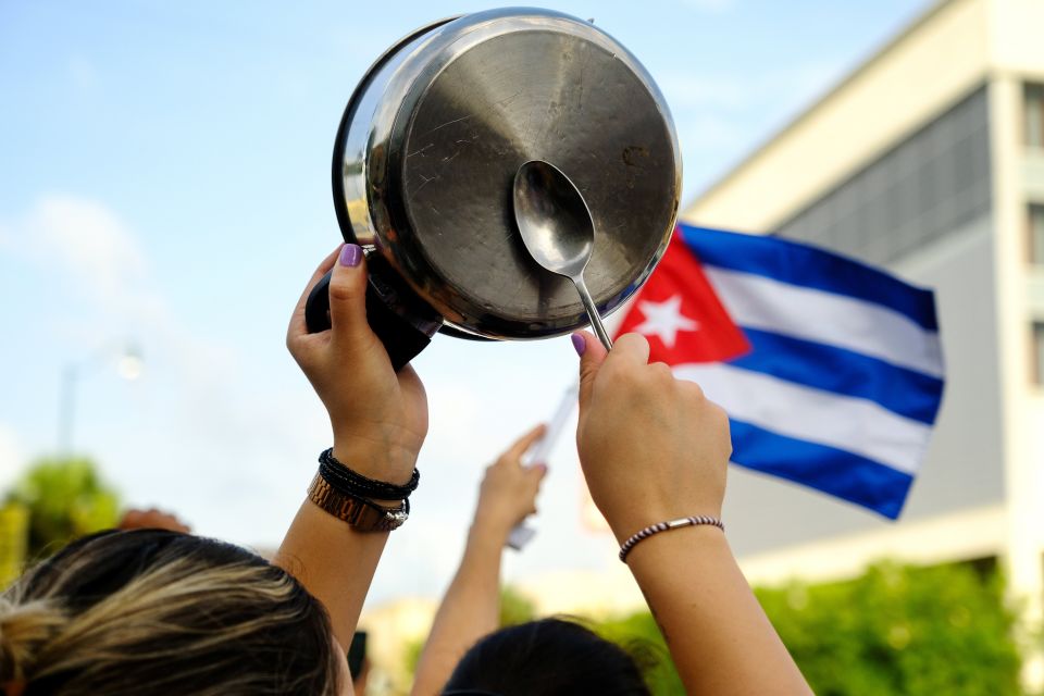 A demonstrator in the Little Havana neighborhood of Miami bangs on a pot July 12 as people rally in solidarity with protesters in Cuba. (CNS/Reuters/Maria Alejandra Cardona)