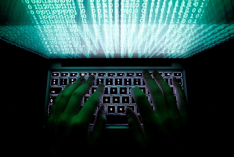 Computer keyboard photo illustration A man types on a computer keyboard in this illustration photo. (CNS/Reuters/Kacper Pempel)
