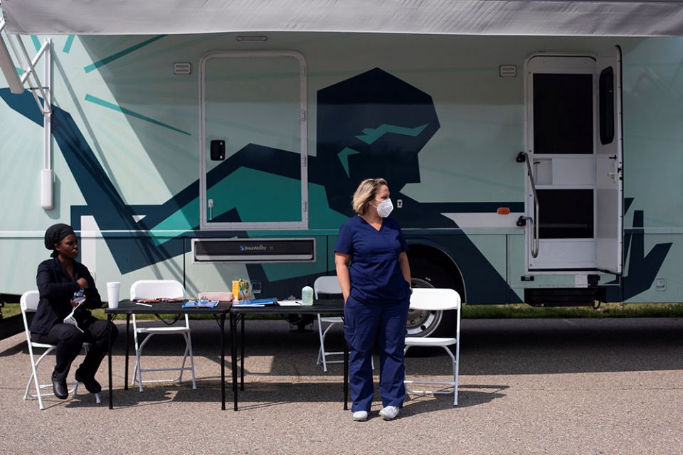 Nurses in Detroit wait for people to come by to receive their COVID-19 vaccine at a mobile pop-up vaccination clinic hosted by the Detroit Health Department with the Detroit Public Schools Community District July 21. (CNS/Reuters/Emily Elconin)