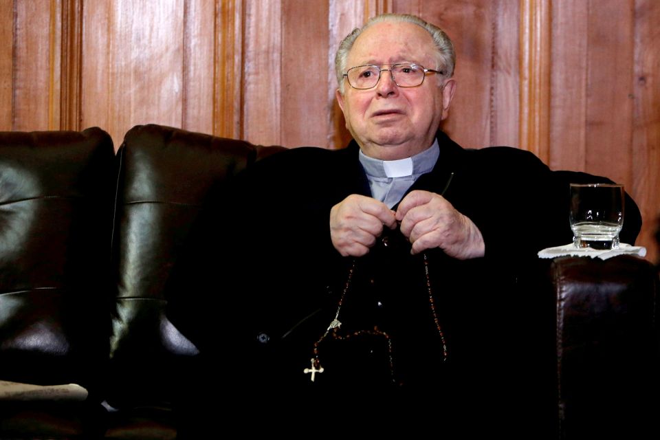 Chilean Fernando Karadima, the defrocked priest at the heart of a sexual abuse case that rocked Chile's Catholic Church, died of natural causes July 25, 2021. He was 90. He is pictured with a rosary inside the Supreme Court building in Santiago Nov. 11, 2