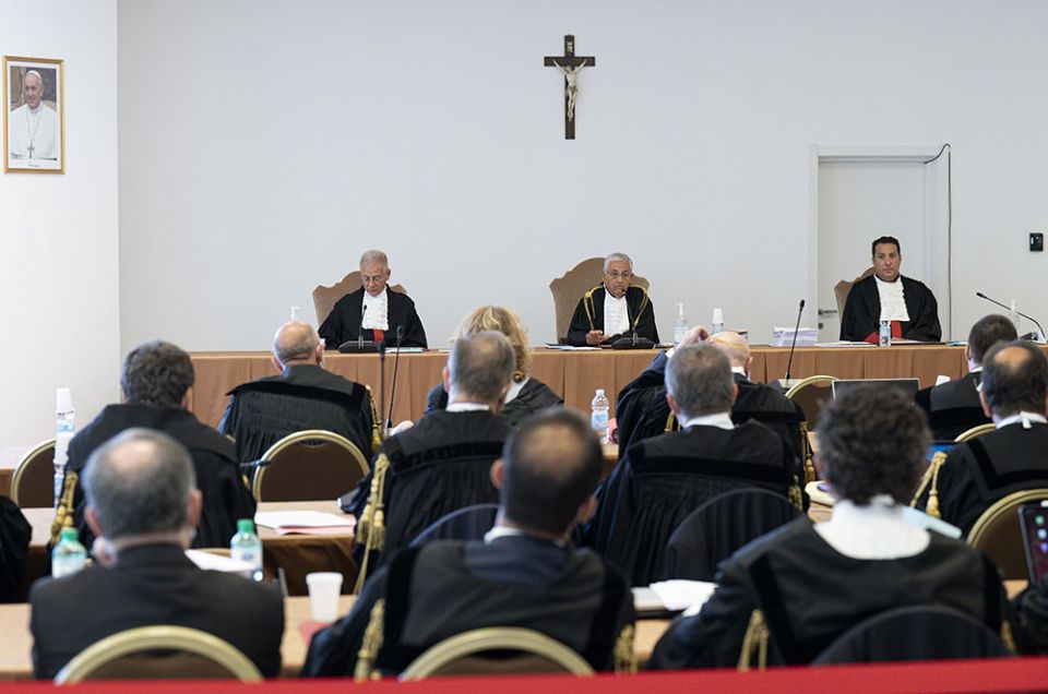 The judges of the Vatican City State criminal court — Venerando Marano, Giuseppe Pignatone and Carlo Bonzano — face dozens of lawyers in a makeshift Vatican courtroom July 27, as the trial of 10 defendants in a financial malfeasance case begins. (CNS)