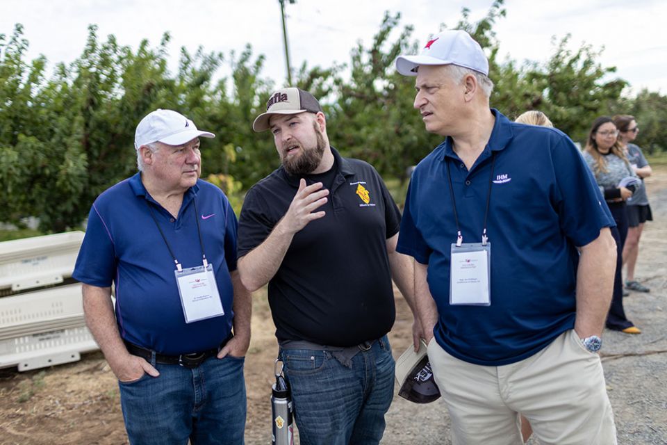 Seminarian John Washington, center, of the Yakima Diocese speaks with immersion participants Fr. Charles Keeney, left, of the Diocese of Brooklyn, New York, and Msgr. Jim Schillinger of the Atlanta Archdiocese.
