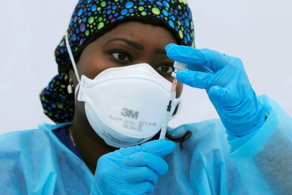 Nurse prepares dose of COVID-19 vaccine Registered nurse Sheba Phillip prepares a syringe with a dose of the Pfizer-BioNTech COVID-19 vaccine during a vaccination event for local adolescents and adults outside the Bronx Writing Academy school June 4 in New York City. (CNS/Reuters/Mike Segar)