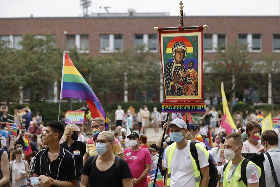 Activists carrying a rainbow flag and a banner with an image of Mary and the Christ Child attend the second "Marzahn Pride" march in Berlin July 17. (CNS/Reuters/Axel Schmidt)