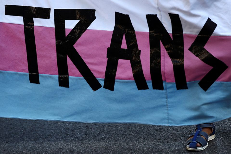 A person holds a "Trans" banner in this illustration photo. (CNS/Reuters/Sergio Perez)