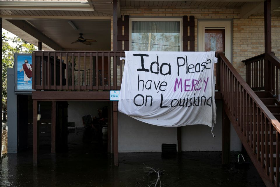 A blanket hangs outside a house Jean Lafitte, La., Sept. 2, 2021, following Hurricane Ida's landfall. The blanket reads "Ida please have mercy on Louisiana." (CNS photo/Marco Bello, Reuters)