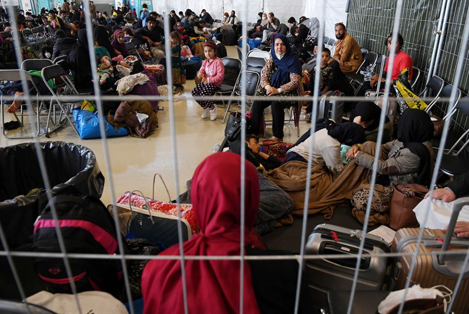 Afghan refugees are processed at Ramstein Air Base Sept. 8 in Germany. (CNS/Olivier Douliery, pool via Reuters)