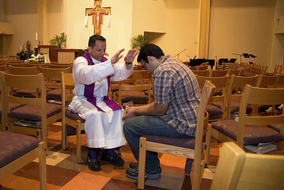 A priest blesses a student In this 2015 file photo, a priest blesses a student involved with the Fellowship of Catholic University Students at a church on the campus of the University of Texas at Austin at the University Catholic Center. (CNS/Courtesy of FOCUS)