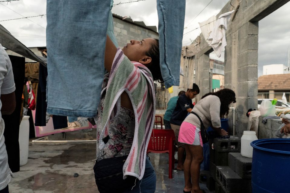 Asylum-seeking migrants from Central America do their laundry in the public square of Reynosa, Mexico, Aug. 27, 2021. (CNS photo/Go Nakamura, Reuters)