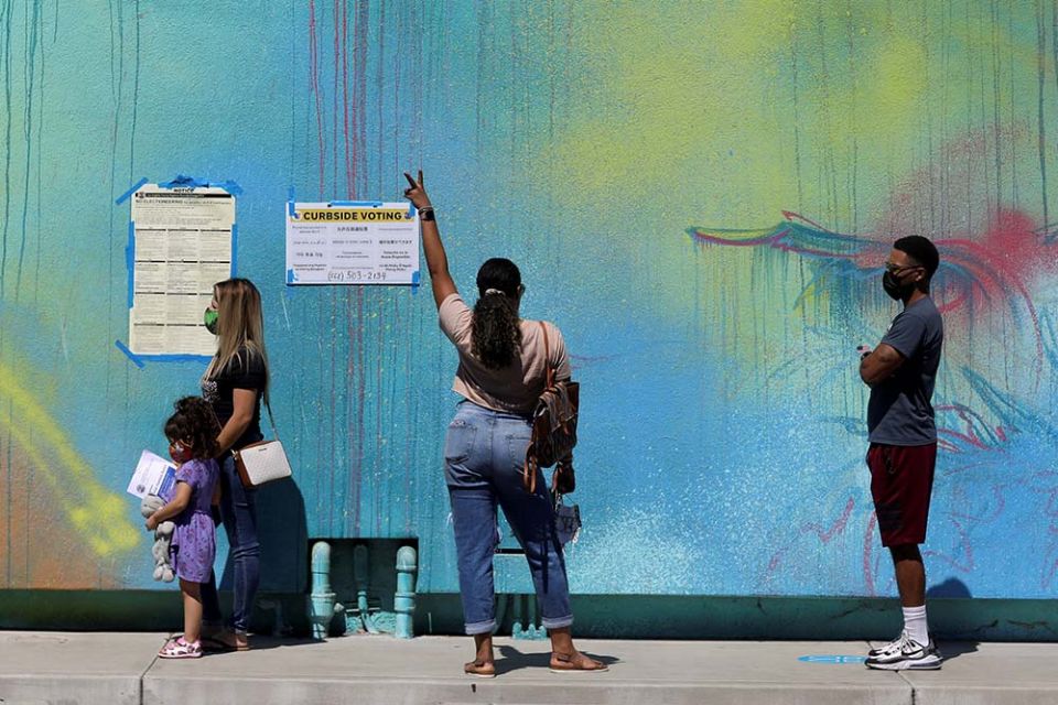 A woman in Long Beach, California, gestures as people wait to vote in the state's gubernatorial recall election Sept. 14, 2021, outside the Museum of Latin American Art. (CNS/Reuters/David Swanson)