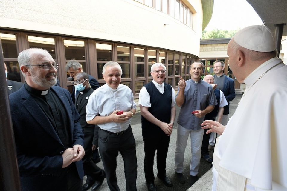Pope Francis talks with members of the Society of Jesus at the apostolic nunciature in Bratislava, Slovakia, Sept. 12.