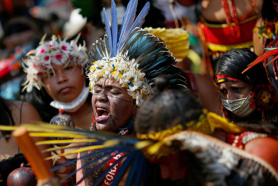 Brazilian Indigenous people march to protest President Jair Bolsonaro Brazilian Indigenous people take part in the second march of Indigenous women to protest President Jair Bolsonaro Sept. 10 in Brasilia. (CNS photo/Reuters/Adriano Machado)