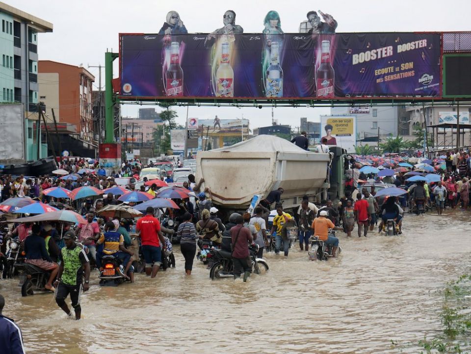 People make their way through a flooded street after heavy rains in Douala, Cameroon, Aug. 12. Catholics in Africa are calling for greater protection of the Congo Basin to fight climate change. (CNS photo/Joel Kouam, Reuters)