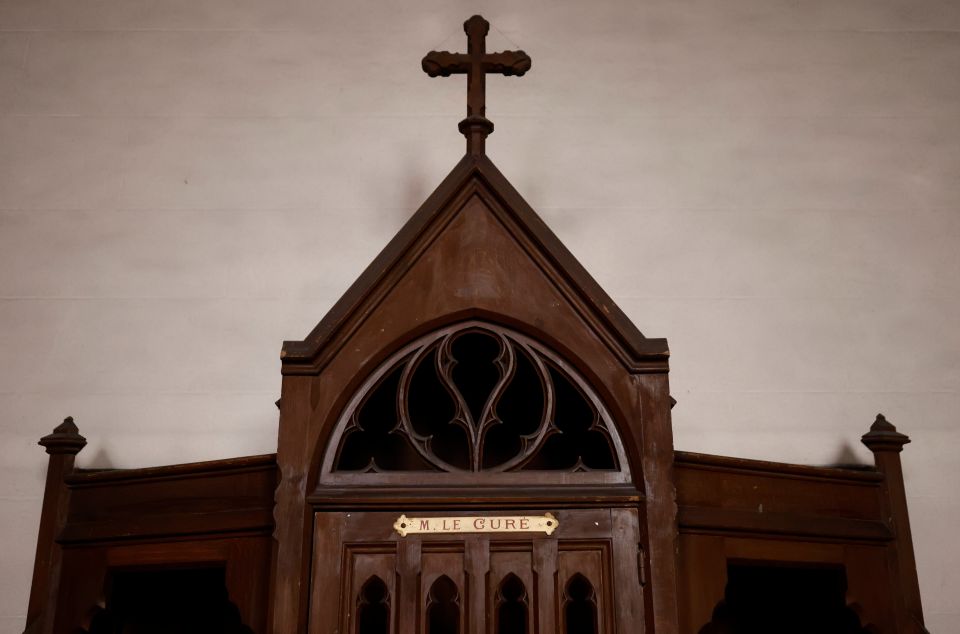 A confessional on which is written: "M. the Priest" is pictured in a Catholic church near Nantes, France, Oct. 5, 2021. Church and government leaders in France are at odds over whether priests should be required to report the abuse of minors if they learn