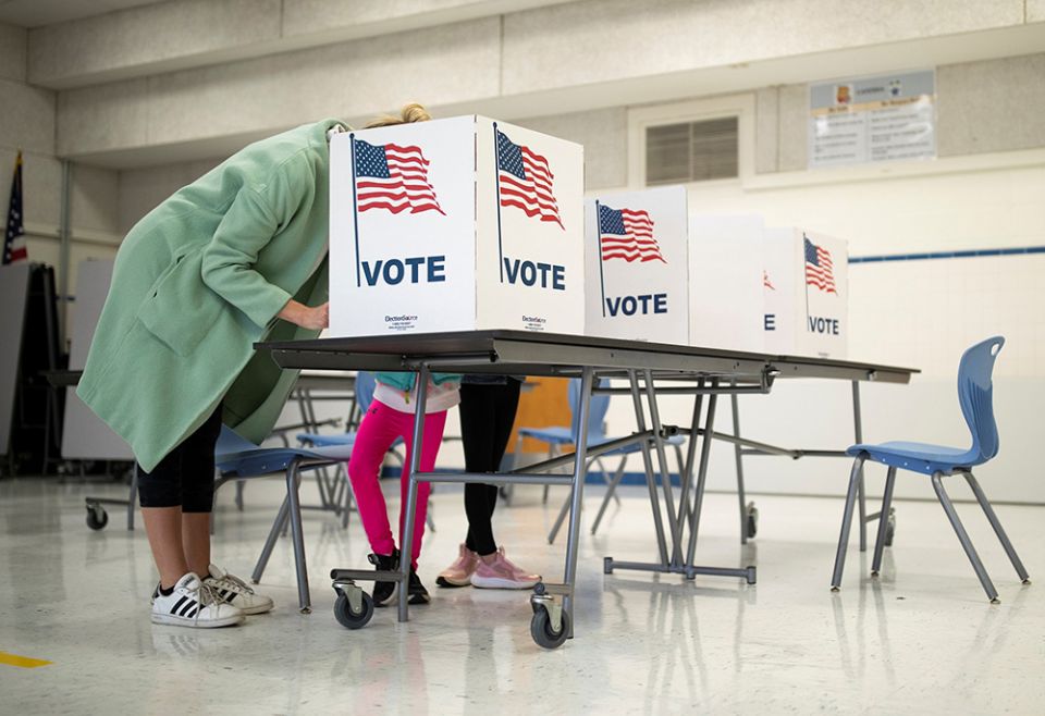 A mother in McLean, Virginia, casts her vote during the governor's race Nov. 2, 2021. (CNS/Reuters/Tom Brenner) A mother in McLean, Virginia, casts her vote during the governor's race Nov. 2, 2021. (CNS/Reuters/Tom Brenner)