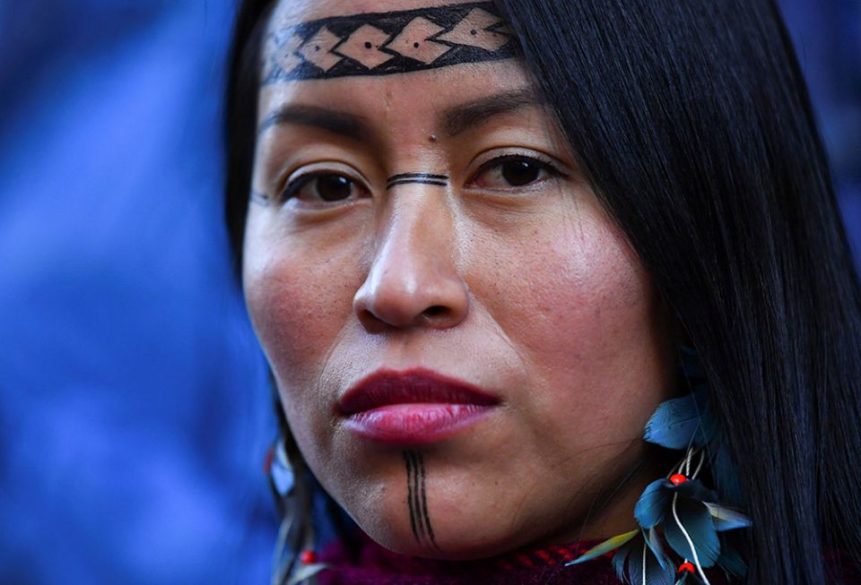 An Indigenous woman takes part in a protest outside the U.N. Climate Change Conference in Glasgow, Scotland, Nov. 10, 2021. (CNS/Reuters/Dylan Martinez)
