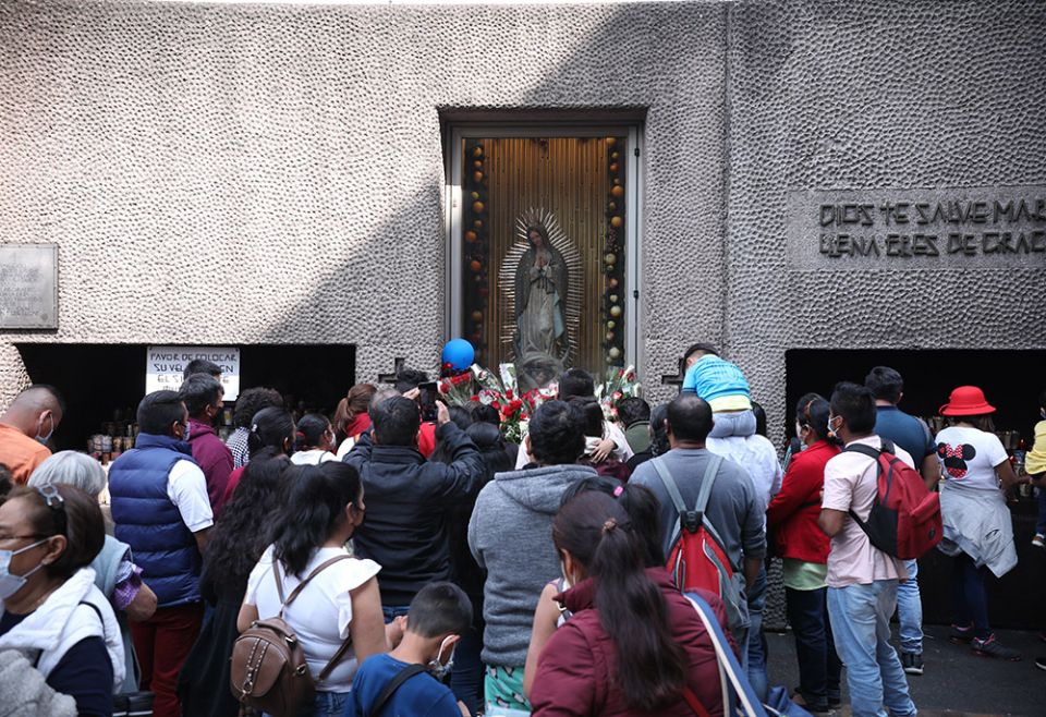 Worshipers pray near an image of Our Lady of Guadalupe outside the basilica with her name Nov. 21, 2021, in Mexico City, during the opening of the Nov. 21-28 Ecclesial Assembly of Latin America and the Caribbean. (CNS/Emilio Espejel)