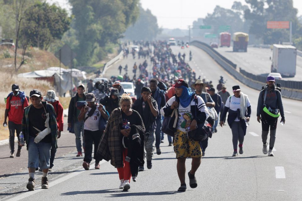 Migrants walk on a highway in San Martín Texmelucan de Labastida, Mexico, Dec. 10, 2021, as they head to Mexico City to apply for asylum and refugee status.  (CNS photo/Imelda Medina, Reuters)
