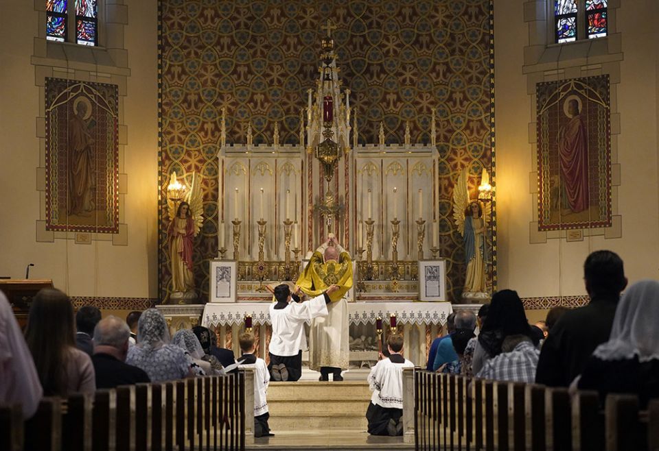 Fr. Stephen Saffron, parish administrator, elevates the Eucharist during a Tridentine Mass at St. Josaphat Church in the Queens borough of New York City in this July 18 file photo. (CNS/Gregory A. Shemitz)