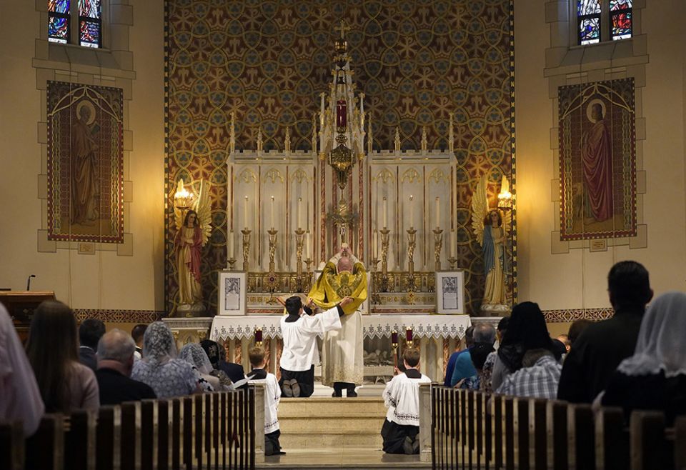 Fr. Stephen Saffron, parish administrator, elevates the Eucharist during a Tridentine Mass at St. Josaphat Church in the Queens borough of New York City in this July 18 file photo. (CNS/Gregory A. Shemitz) Fr. Stephen Saffron, parish administrator, elevates the Eucharist during a Tridentine Mass at St. Josaphat Church in the Queens borough of New York City in this July 18 file photo. (CNS/Gregory A. Shemitz)
