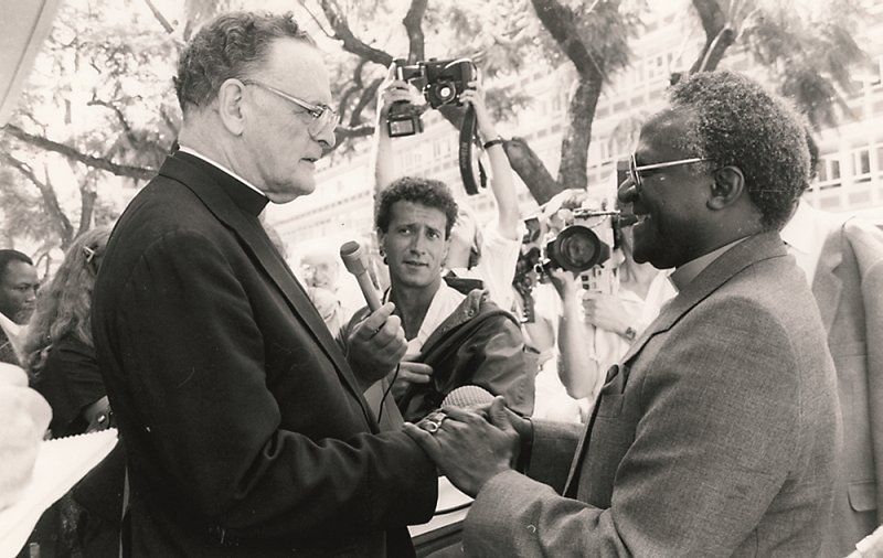 Anglican Archbishop Desmond Tutu of Cape Town shows solidarity with Catholic Archbishop Denis Hurley of Durban in a 1985 photo. Hurley was charged with revealing atrocities committed by the apartheid regime in what is now Namibia. 