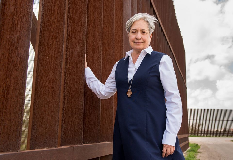 Sr. Norma Pimentel, a member of the Missionaries of Jesus, is pictured along a border wall between Texas and Mexico in late February 2018. (CNS/Courtesy of the University of Notre Dame/Barbara Johnston)