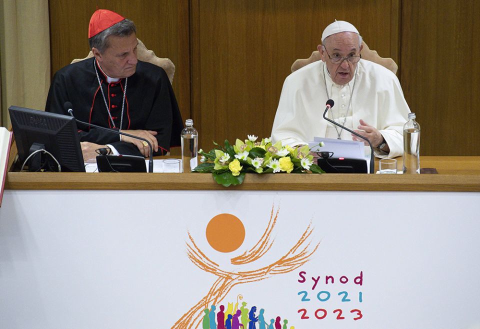 Pope Francis speaks as Maltese Cardinal Mario Grech, secretary-general of the Synod of Bishops, looks on during a meeting with representatives of bishops' conferences from around the world at the Vatican in this Oct. 9, 2021, file photo. (CNS/Paul Haring) Pope Francis speaks as Maltese Cardinal Mario Grech, secretary-general of the Synod of Bishops, looks on during a meeting with representatives of bishops' conferences from around the world at the Vatican in this Oct. 9, 2021, file photo. (CNS/Paul Haring)