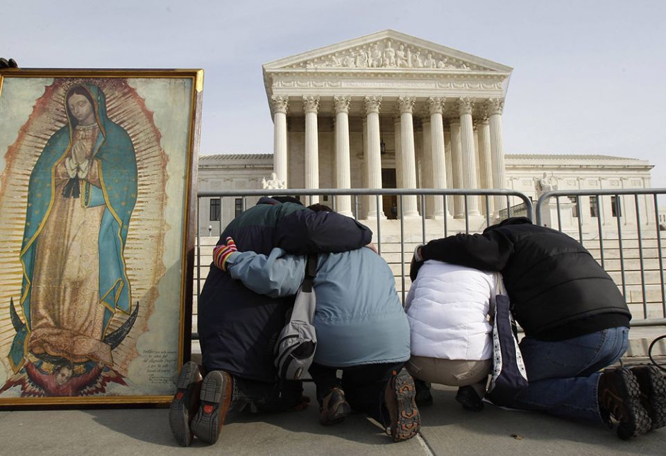 March for Life participants kneel in prayer alongside an image of Our Lady of Guadalupe in front of the Supreme Court building Jan. 24, 2011, in Washington. (CNS/Reuters/Jim Young) March for Life participants kneel in prayer alongside an image of Our Lady of Guadalupe in front of the Supreme Court building Jan. 24, 2011, in Washington. (CNS/Reuters/Jim Young)
