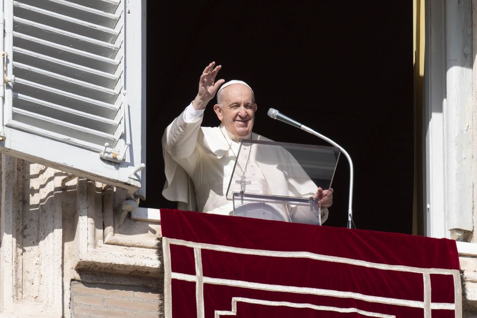 Pope Francis greets the crowd as he leads the Angelus from the window of his studio overlooking St. Peter's Square at the Vatican Jan. 23, 2022. (CNS photo/Vatican Media)