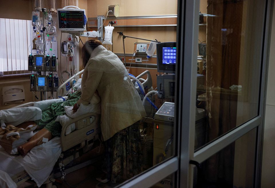 The mother of a COVID-19 patient stands at the bedside of the patient in the intensive care unit of the St. Mary Medical Center Feb. 1 in Apple Valley, California. (CNS/Reuters/Shannon Stapleton) The mother of a COVID-19 patient stands at the bedside of the patient in the intensive care unit of the St. Mary Medical Center Feb. 1 in Apple Valley, California. (CNS/Reuters/Shannon Stapleton)