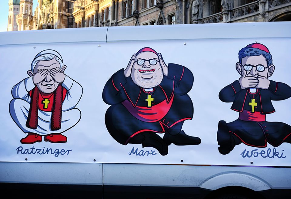  large poster is attached to a van Jan. 19 in Munich, depicting retired Pope Benedict XVI, Cardinal Reinhard Marx of Munich and Freising, and Archbishop Rainer Maria Woelki of Cologne, during a demonstration in protest of church handling of abuse. (CNS)