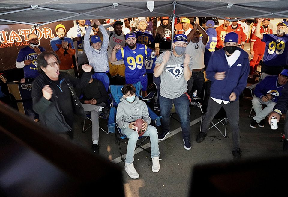 Los Angeles Rams fans at a tailgate party in the SoFi Stadium parking lot in Inglewood, California, celebrate the team's victory over the San Francisco 49ers in the NFC Championship game Jan. 30, 2022, amid the pandemic. (CNS/Reuters/Bing Guan)