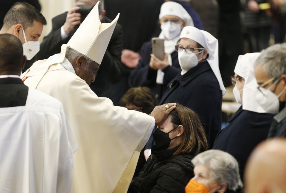 Cardinal Peter Turkson, former prefect of the Dicastery for Promoting Integral Human Development, blesses a woman as he celebrates Mass marking World Day of the Sick, in St. Peter's Basilica at the Vatican Feb. 11, 2022. (CNS photo/Paul Haring)