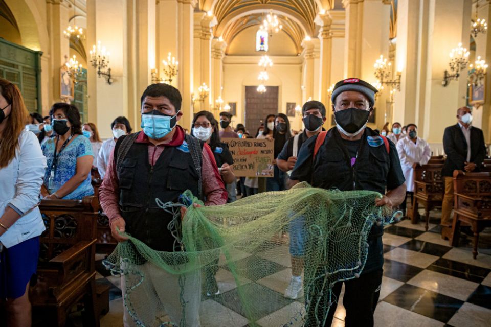 Fishing families affected by a January oil spill on the Peruvian coast offer tools of their labor during the offertory during Mass Feb. 13, 2022, in the city's cathedral. (CNS/courtesy Archdiocese of Lima)