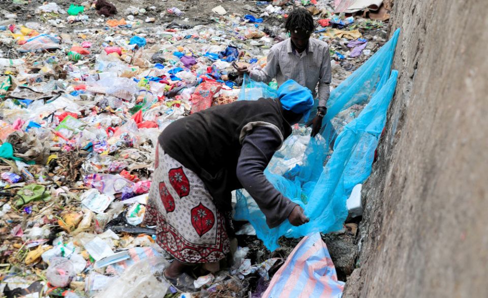 A woman uses a net to sort recyclable plastic materials from a dumping site in Nairobi, Kenya, Feb. 1, 2022. (CNS/Reuters/Thomas Mukoya)