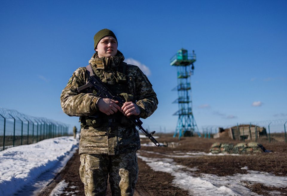 A Ukrainian frontier guard patrols an area along the Ukrainian-Russian border Feb. 23 in the Kharkiv, Ukraine. (CNS/Reuters/Antonio Bronic)